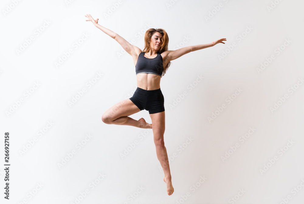 Young dance girl over isolated white wall.