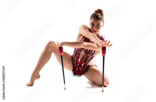 Girl doing rhythmic gymnastics with maces.