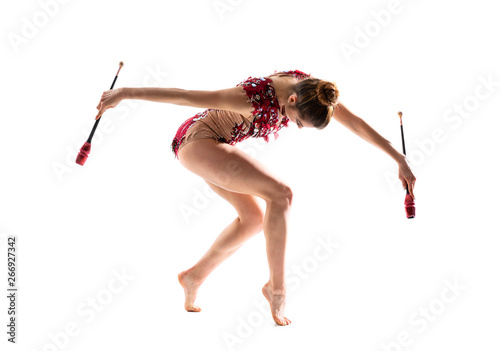 Girl doing rhythmic gymnastics with maces. photo