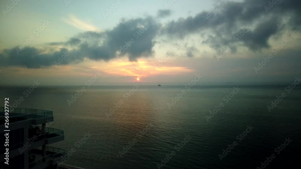 Dramatic dark cloud movement sky with beginning of deep orange sunrise before sun becomes visible. Dramatic dark cloud movement sky with beginning of deep orange sunrise before sun becomes visible.