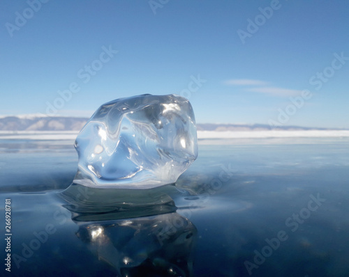 the sun's rays are refracted in crystal clear pieces of ice. winter landscape. Lake Baikal