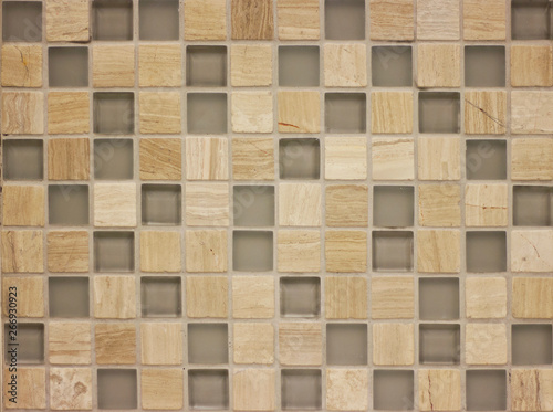 background mosaic tile of brown and beige squares of different tones and transparency monochromatic and with texture and ornament © Irina