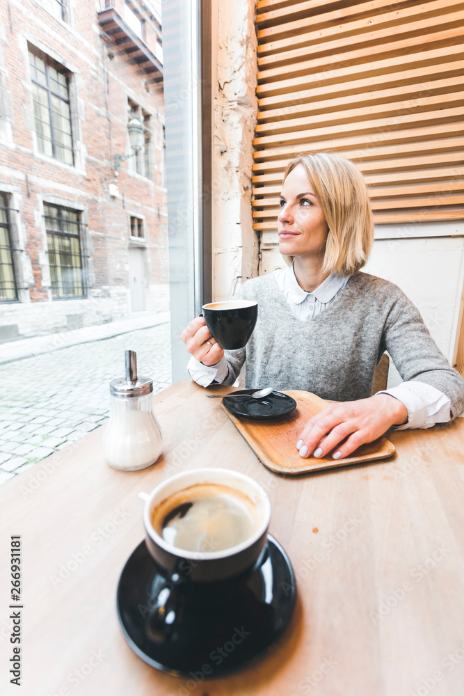 Woman drinking coffee in a cafe Woman drinking coffee in a cafe