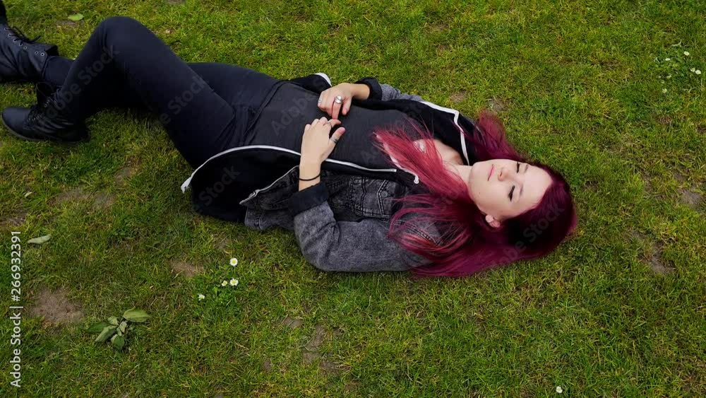 emo girl with purple hair pondering about life on the floor wide shot emo girl with purple hair pondering about life on the floor wide shot