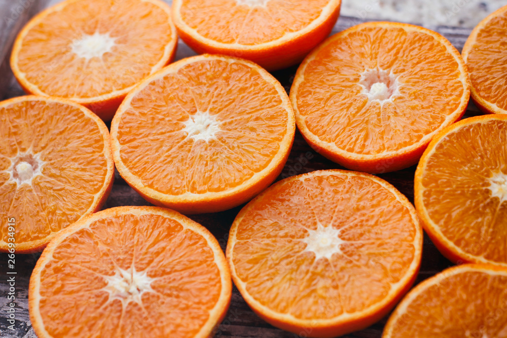 Fresh sliced oranges on wooden table. Halves of fruit. Fresh sliced oranges on wooden table. Halves of fruit.