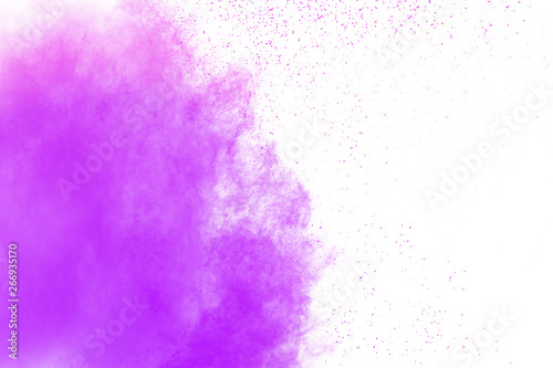 Purple color powder explosion cloud on white background.Closeup of Purple dust particles splash on background.