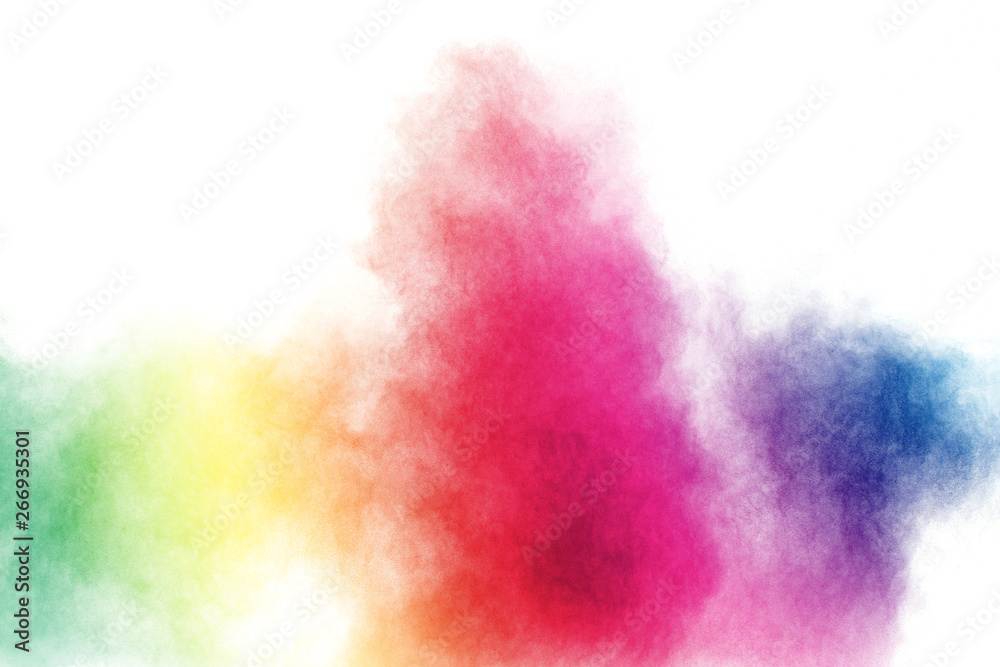 Abstract multicolored powder explosion on white background.  Freeze motion of  dust particles splash. Painted Holi.