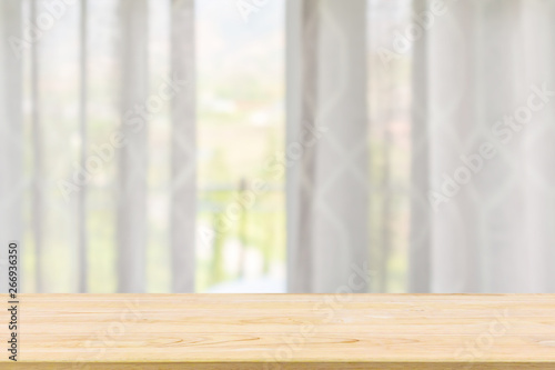 Empty wood table top with window curtain abstract blur background for product display