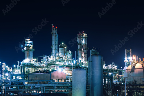 Manufacturing of petroleum industrial plant with gas tanks at night photo