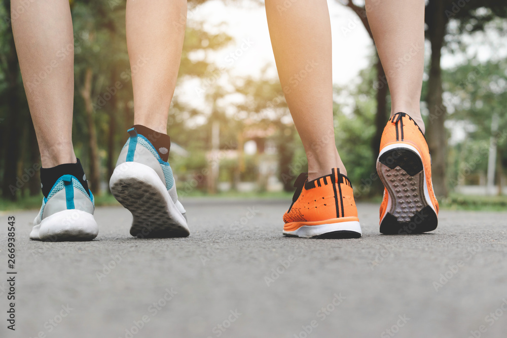 Closeup people walking with sport shoes on road in park for health concept. Closeup people walking with sport shoes on road in park for health concept.
