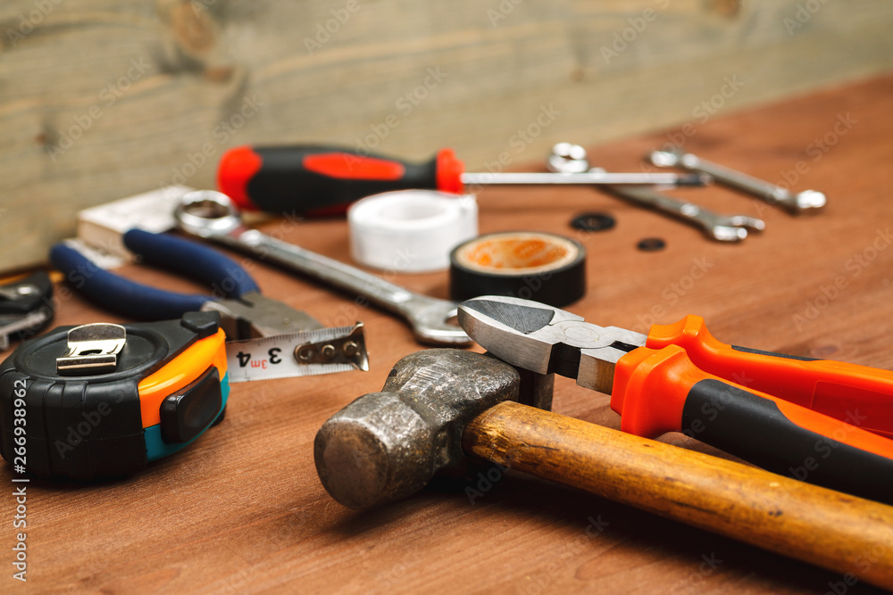 Massive hammer with other tools on a wooden table in workshop Massive hammer with other tools on a wooden table in workshop