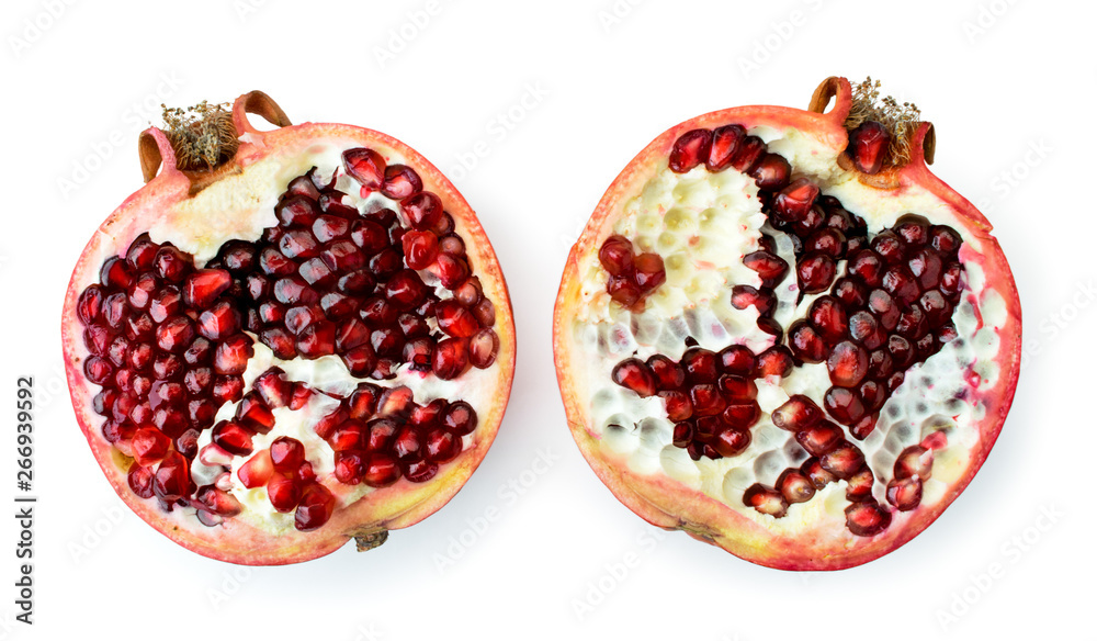 Ripe pomegranate broken into two halves on a white. The form of the top. Ripe pomegranate broken into two halves on a white. The form of the top.