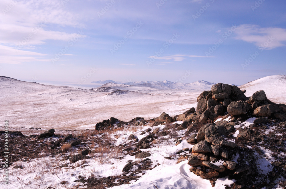 Obraz premium Early morning sunrise in Tazheran steppes. Snow-covered hills are colored in shades of ultra-violet. Photo toned.