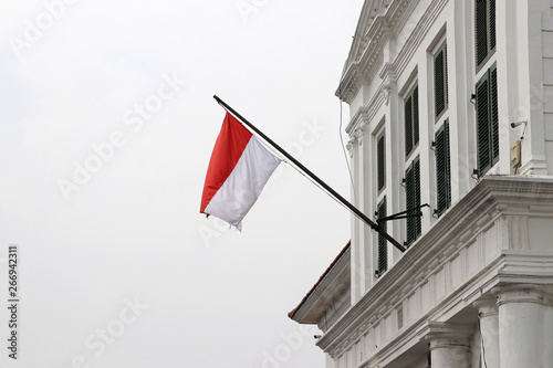 Indonesia flag on the building blow by the wind. photo