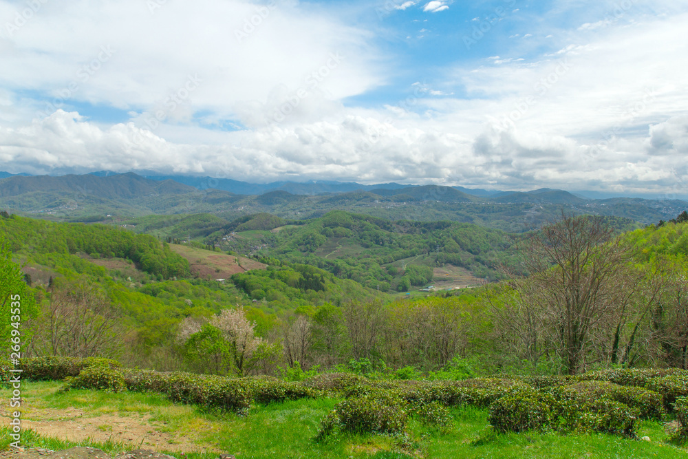 scenic view on mountains,green hills and cloudy sky