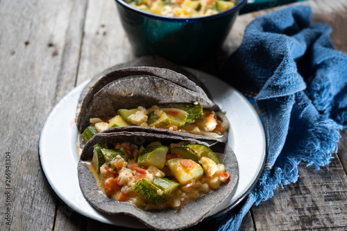 Mexican zucchini stew tacos with blue tortilla
