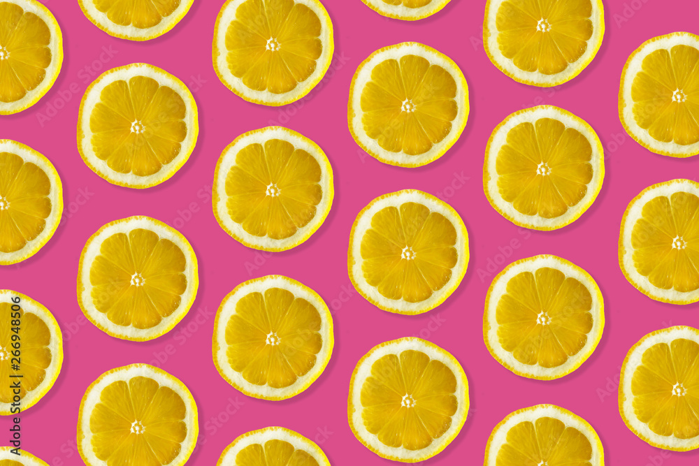 Creative pattern made of lemon. top view of fruit fresh limes slices on pink colorful background. 