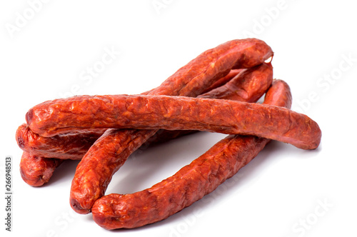 Small smoked sausages isolated on a white background.