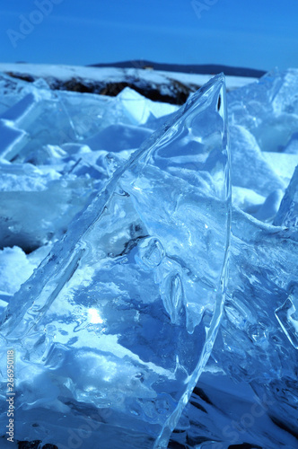 the sun's rays are refracted in crystal clear pieces of ice. winter landscape. Lake Baikal