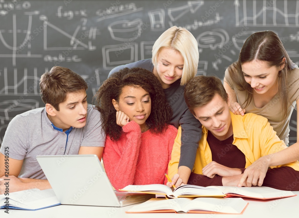 Four Young students studying subject on background Four Young students studying subject on background