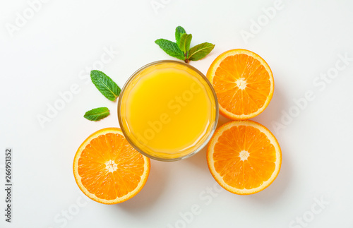 Flat lay composition with orange juice  oranges and mint on white background  space for text. Citrus drink and fruits