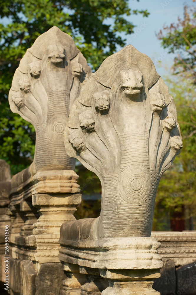 Stone nagas guarding the ruins of the Hindu temple in the Phimai Historical Park in Nakhon Ratchasima, Thailand.