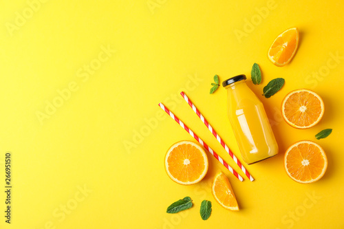 Flat lay composition with oranges, tubules and orange juice in bottle, space for text. Fresh natural drink