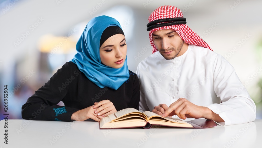 Portrait of arab couple with laptop on  background