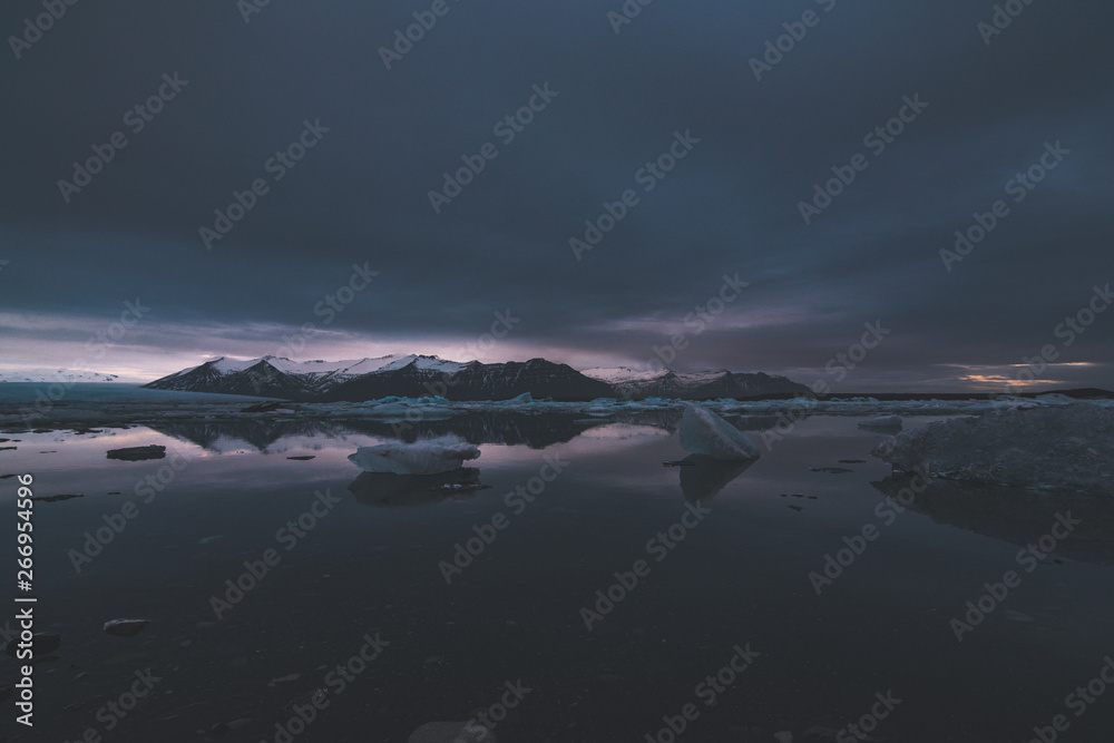 Jokulsarlon, glacier lagoon in Iceland at night with ice floating in water. Cold arctic nature landscape scenery. Ice melting.