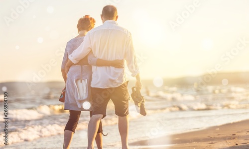 Close-up portrait of an elderly couple hugging on seacoast photo