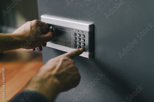 man opens safe, combination lock