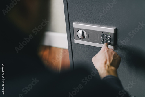 man opens safe, combination lock