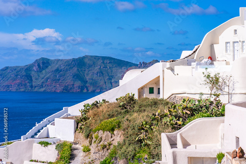Santorini landscape with traditional whitewashed houses and view of Aegean Sea in Oia, Greece