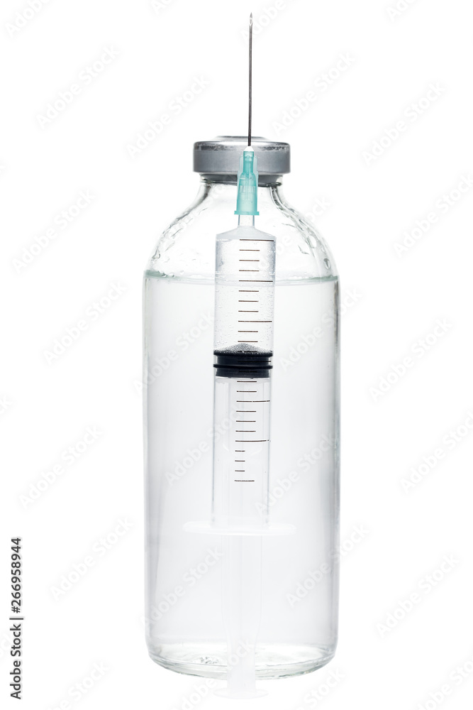 syringe with a needle filled with a dose of vaccine in the background glass bottle with medical preparation for the treatment of health. syringe with a needle filled with a dose of vaccine in the background glass bottle with medical preparation for the treatment of health.