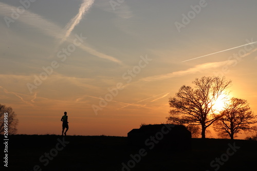Runner silhouette at sunset background