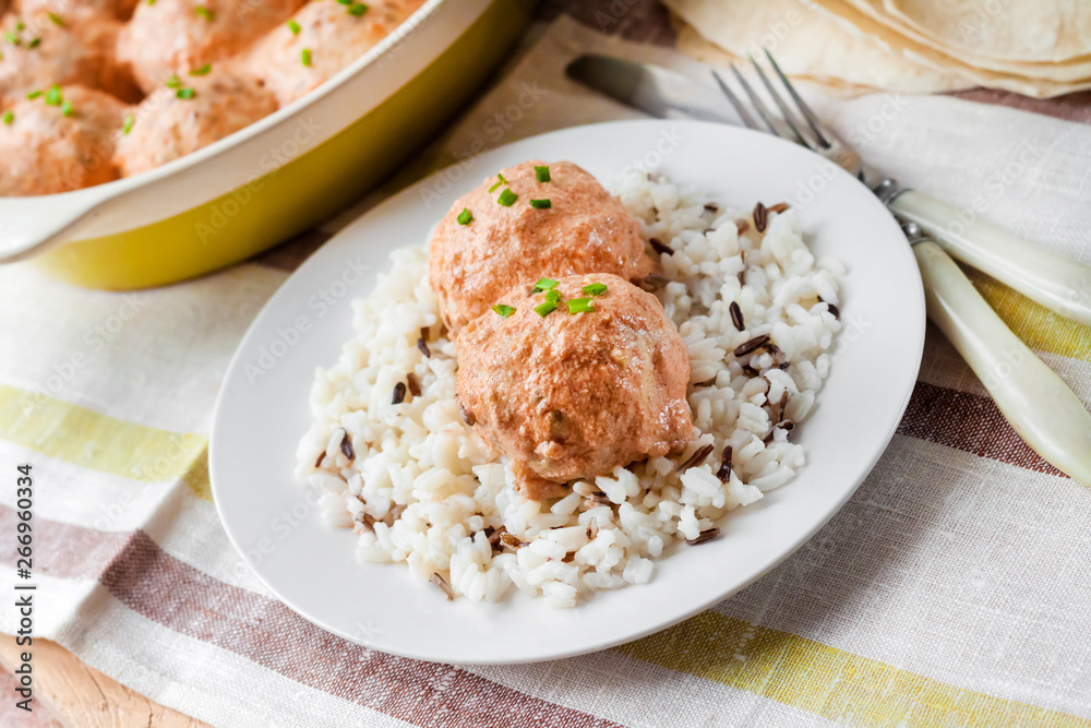 Chicken meatballs in creamy tomato sauce with rice Chicken meatballs in creamy tomato sauce with rice