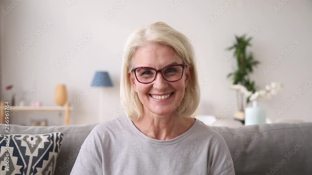 Older woman looking at camera talking laughing making video call