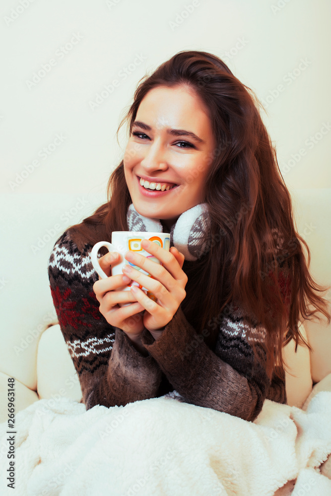 young pretty woman sitting in comfortable chair with coffee and blanket, winter season lifestyle people concept young pretty woman sitting in comfortable chair with coffee and blanket, winter season lifestyle people concept