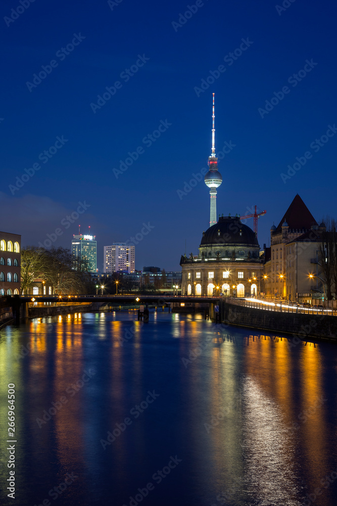 Cityscape of Berlin. Old and modern buildings and their reflections on the Spree River in Germany, at dusk. Fernsehturm TV Tower is in the background.