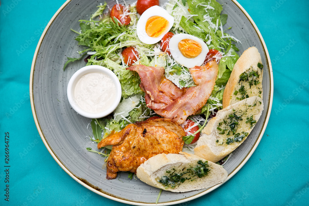 Chicken ceasar salad. Chicken, pancetta, eggs, tomatoes with garlic bread with caesar sauce. Chicken ceasar salad. Chicken, pancetta, eggs, tomatoes with garlic bread with caesar sauce.