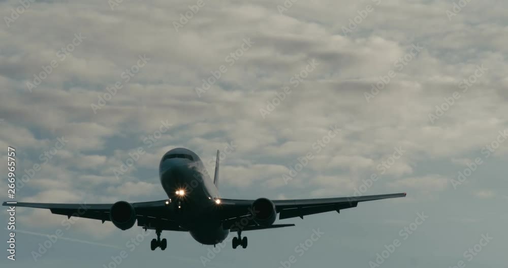 Cinematic shot of a passenger jet airplane about to land. 4K telephoto shot. Cinematic shot of a passenger jet airplane about to land. 4K telephoto shot.