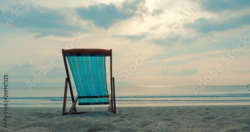 On a Tropical Beach Close-Up Chaise Longue Aainst the Sea and a Beautiful Sunset or Sunrise, Along the Tropical Coast, Against the Ocean. Concept of a tropical summer party. photo