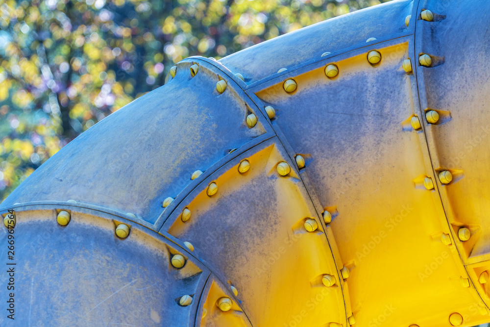 Yellow plastic pipe tunnel on a children's playground on a sunny day. Close-up of gaming equipment. pipe toy tool for enjoy Yellow plastic pipe tunnel on a children's playground on a sunny day. Close-up of gaming equipment. pipe toy tool for enjoy