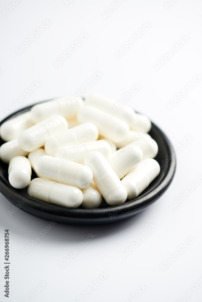 Creatine capsules. Bodybuilding food supplement on white background. Creatine capsules. Bodybuilding food supplement on white background.