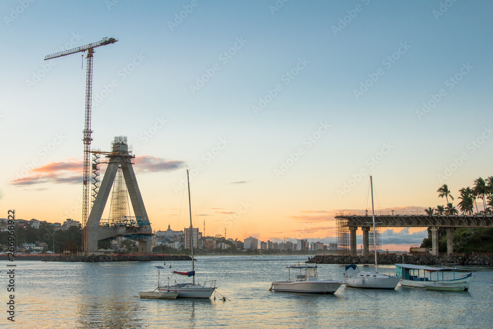 View of Construction of bridge with crane and boats in water