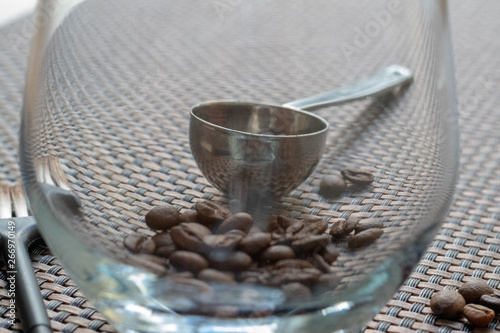 coffee beans in a glass with a scoop