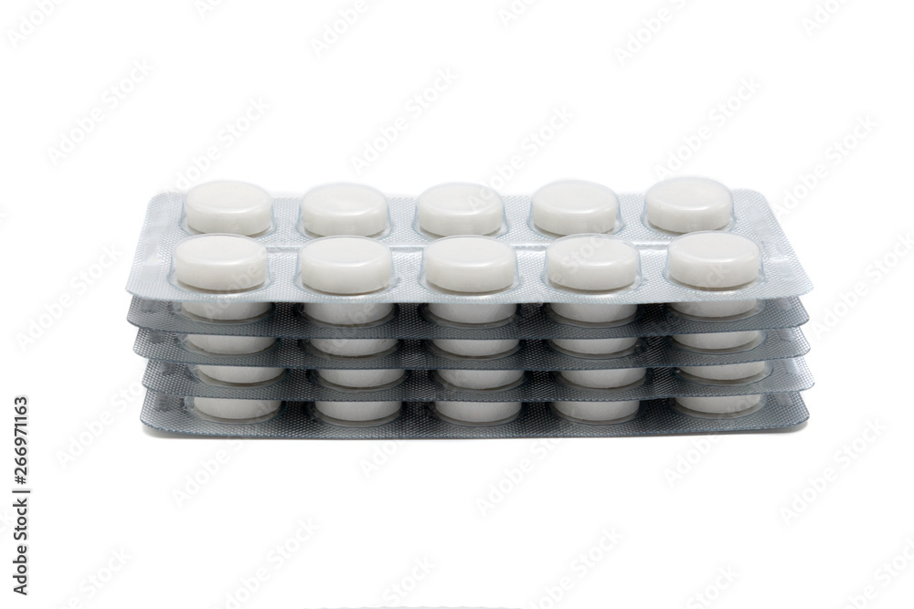white pills in packaging sheets on white background white pills in packaging sheets on white background