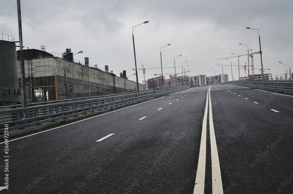 empty asphalt road with nobody, and city skyscraper.