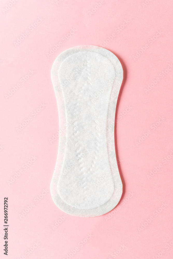 Feminine hygiene pad on a pink background. Concept of feminine hygiene during menstruation. top view. Feminine hygiene pad on a pink background. Concept of feminine hygiene during menstruation. top view.