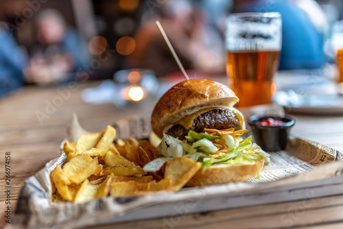 American Brewpub Staple Food: A Burger with French Fries on the Side and a craft beer in a Restaurant in Hamburg, Germany photo